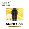 Discover the IGET BAR PLUS POD 6000 PUFFS - Kiwi Pineapple Ice with a refreshing Kiwi Pineapple Ice flavor, offering over 6000 puffs. The image showcases the sleek vaping device alongside vibrant pictures of bananas and pineapples in the background.