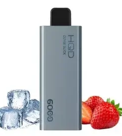 The sleek silver HQD Slick vape device sits beside fresh strawberries and ice cubes, captivating the senses. This "Bundle 5 pcs - Hqd Slick 6000 puffs" promises a refreshing experience.